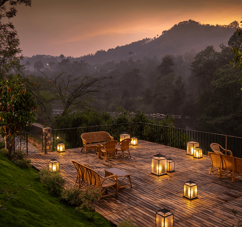 Riverside deck overlooking the Muthirapuzha River at Blanket Riverside Resort, Munnar