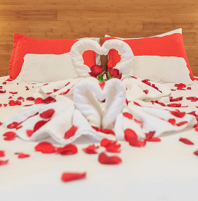 Decorated bed with floral arrangements